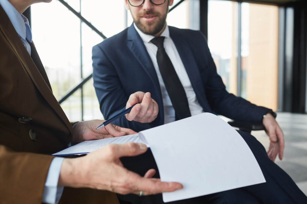 Two professional lawyers discussing legal documents in an office, representing a personal injury lawyer in Nashua, New Hampshire.
