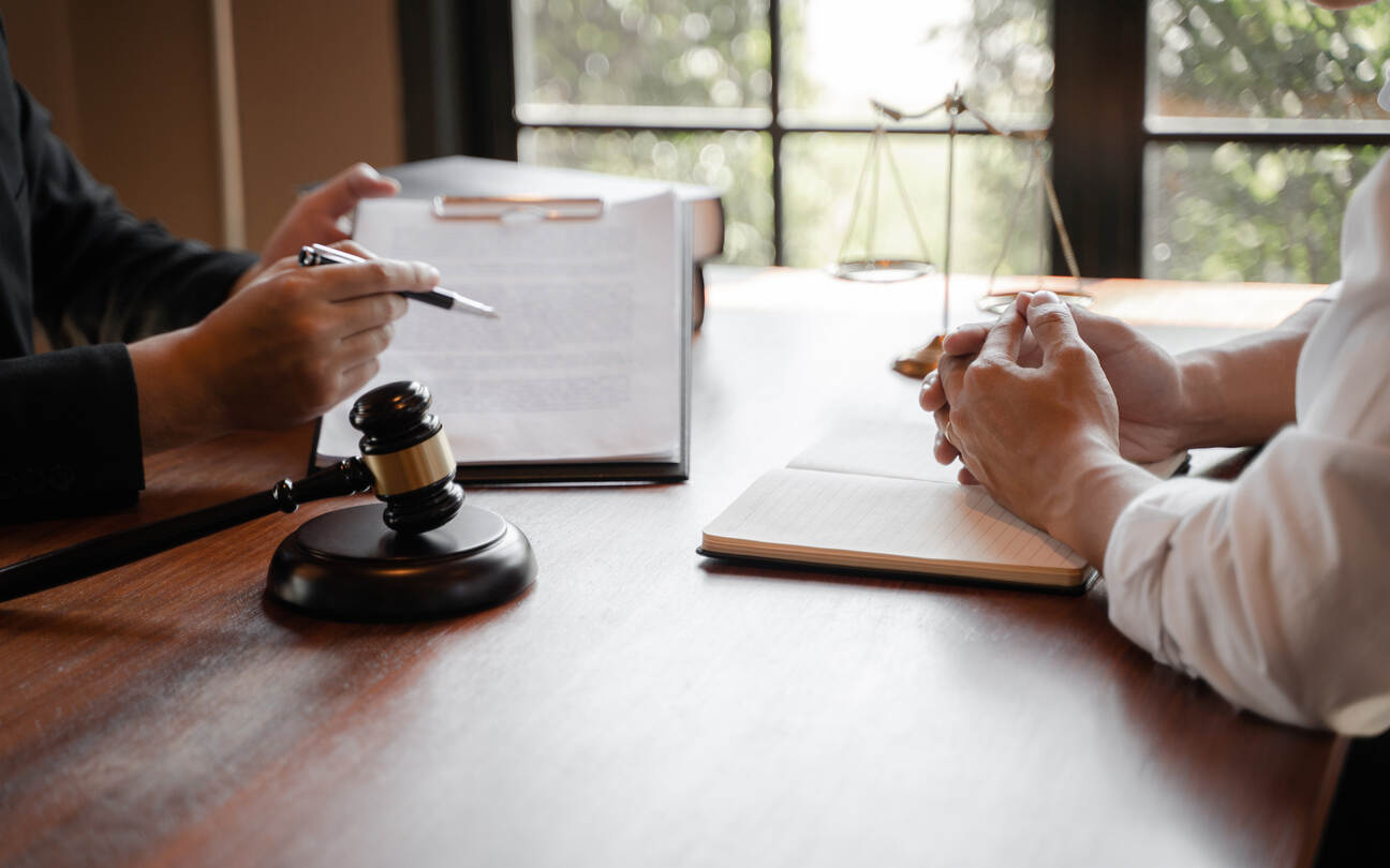 An attorney explaining legal documents to a client, symbolizing expert legal counsel for personal injury cases in Dover.