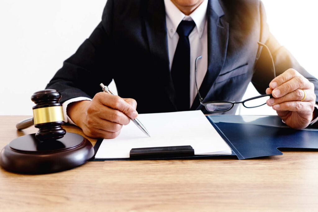 Professional personal injury lawyer in Somersworth reviewing legal documents with a gavel on the desk